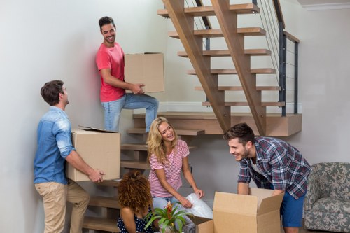 Happy family loading belongings into a rental removal truck
